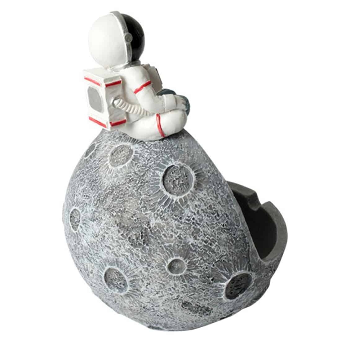 Et ashtro-nutformet askebæger præsenterer sig med en glat, mat overflade i en lys grå nuance. Bægeret har en buet, oval form med en flad bund, der stabiliserer det. Det er udstyret med en dyb fordybning i midten, som simulerer Månen, og har detaljerede teksturer, der efterligner månens overflade med kratere.