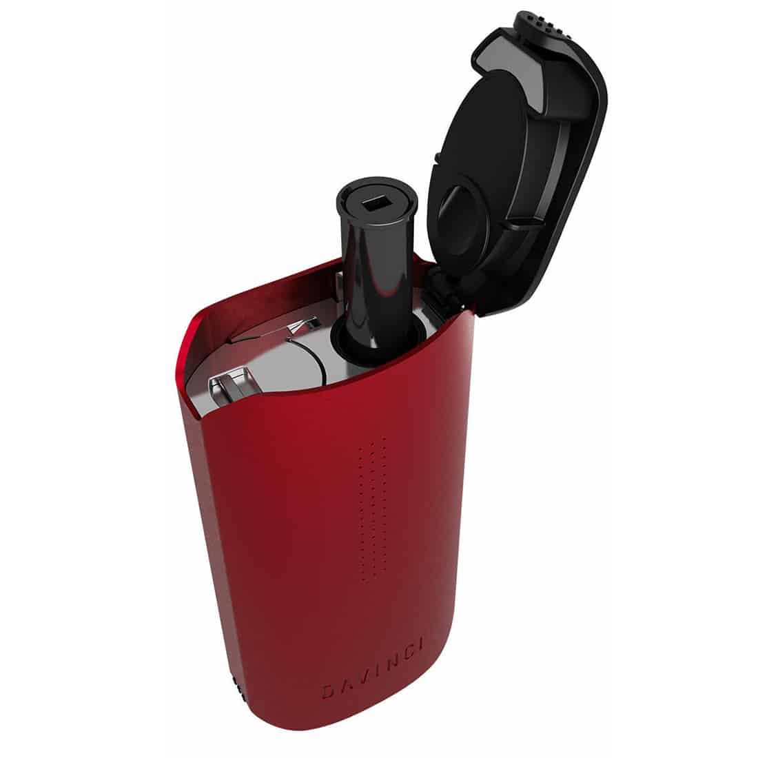 En kompakt enhed med en glat, metalisk overflade dominerer beskrivelsen. Den har en rektangulær form med afrundede kanter og en tydelig skærm på forsiden, hvor information vises. Knappen er placeret under skærmen, og der er en luftventil i toppen. Farverne er primært i nuancer af sort og sølv, hvilket giver et moderne udseende.