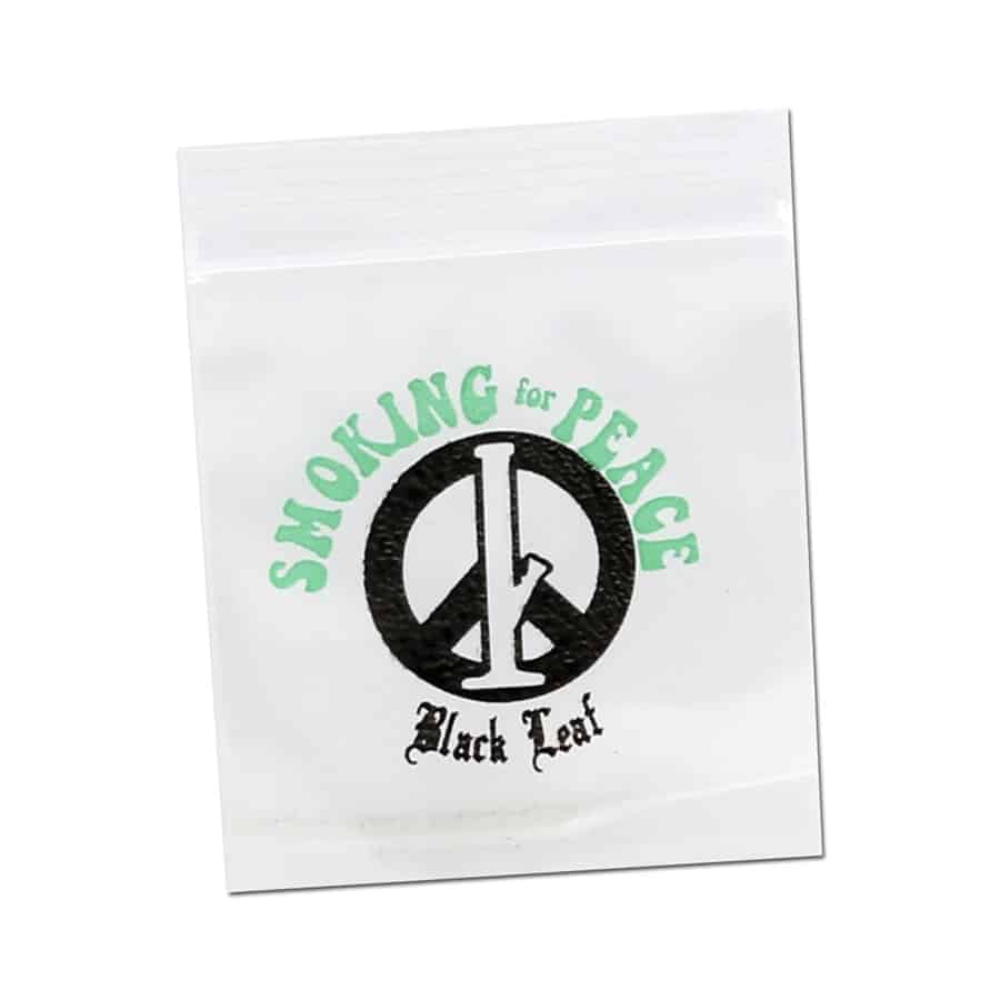 Sorte lynlåsposer præsenteres med et elegant bladmønster i grønne nuancer. Hver pose måler 35 x 35 mm og har en glat overflade med en tydelig, lysere grøn kontrast fra bladene. Lynlåsen er synlig øverst, og poserne er stablet i en pakke med 100 stykker, hvilket giver en ensartet og kompakt præsentation.