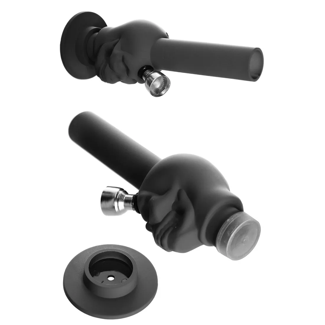 En lille bongs i sort gummi med en skulpturel skull-form. Den har en glat overflade og en mat finish, der skaber en moderne æstetik. Bongen måler 15 cm i højden og har en rund bund, der giver stabilitet. Der er en gennemsigtig skål og en rørformet udgang, hvilket fremhæver designets funktionalitet.