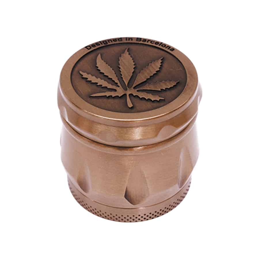 En bronzefarvet krydderikværn med et bladformet præg på overfladen fremstår med en glat, metalagtig tekstur. Den har en rund form med en bred base og en smalere top. Kværnen har en skruelås, der sikrer lukningen, og en små, fine detaljer, der tilføjer dybde til designet. Farven skifter let afhængigt af lyset, hvilket skaber en elegant refleksion.