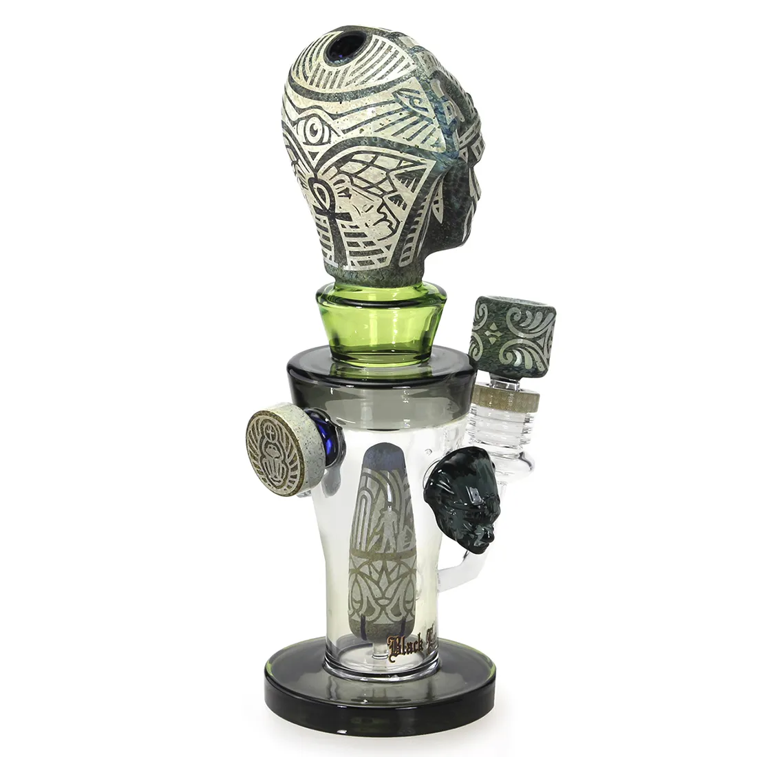 Diffusorbongens krop er udført i klart glas med en sort, bladformet dekoration. Den er 27 cm høj og har en bred, stabil fod. Munden er let buet, og der ses et vandkammer, der skaber en struktur. De fine detaljer i dekorationen tilføjer en organisk følelse, mens den generelle form er slank og elegant.