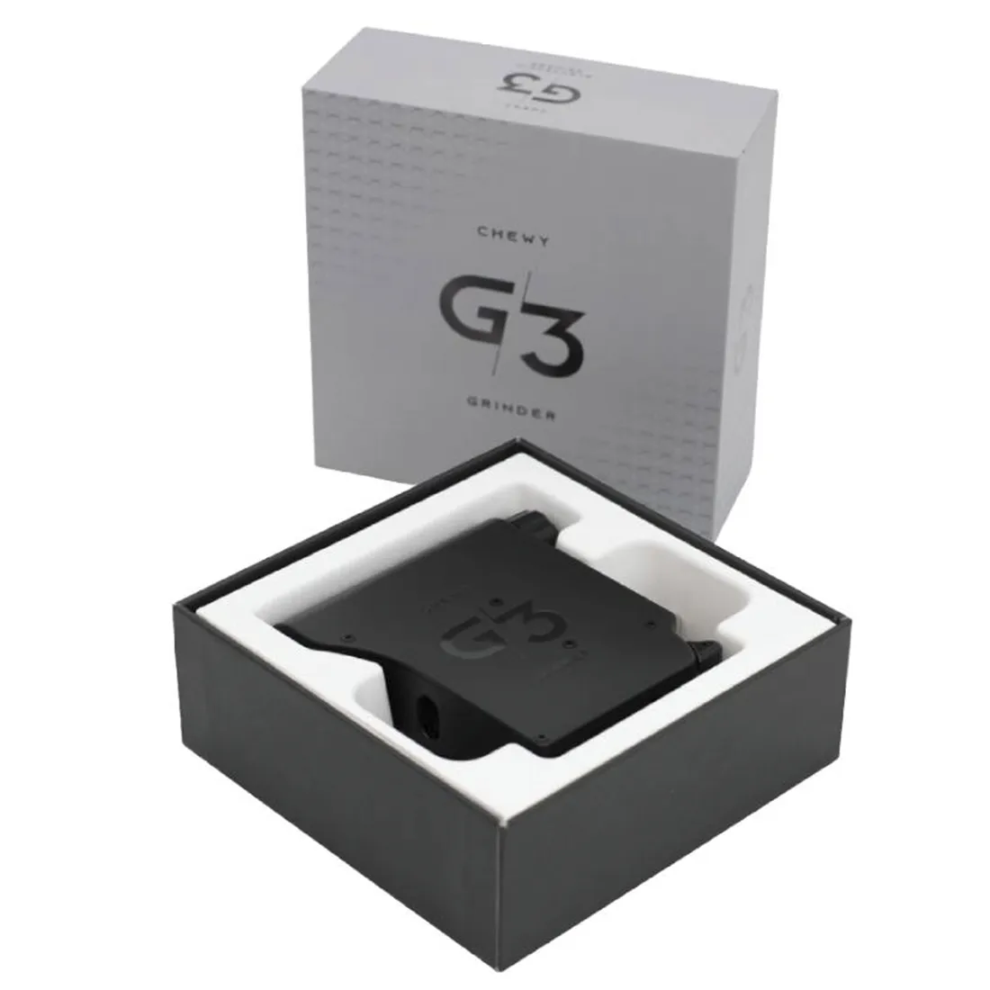 En elektronisk kværn i sort plast med en glat overflade og en kompakt form. Den har en rund, skridsikker base og en gennemsigtig beholder til opbevaring af kværnet materiale. Kværnen har en enkel betjeningsknap i midten samt små ventilationshuller i bunden. Den er designet med en moderne æstetik og klare linjer, der giver et stilrent udtryk.