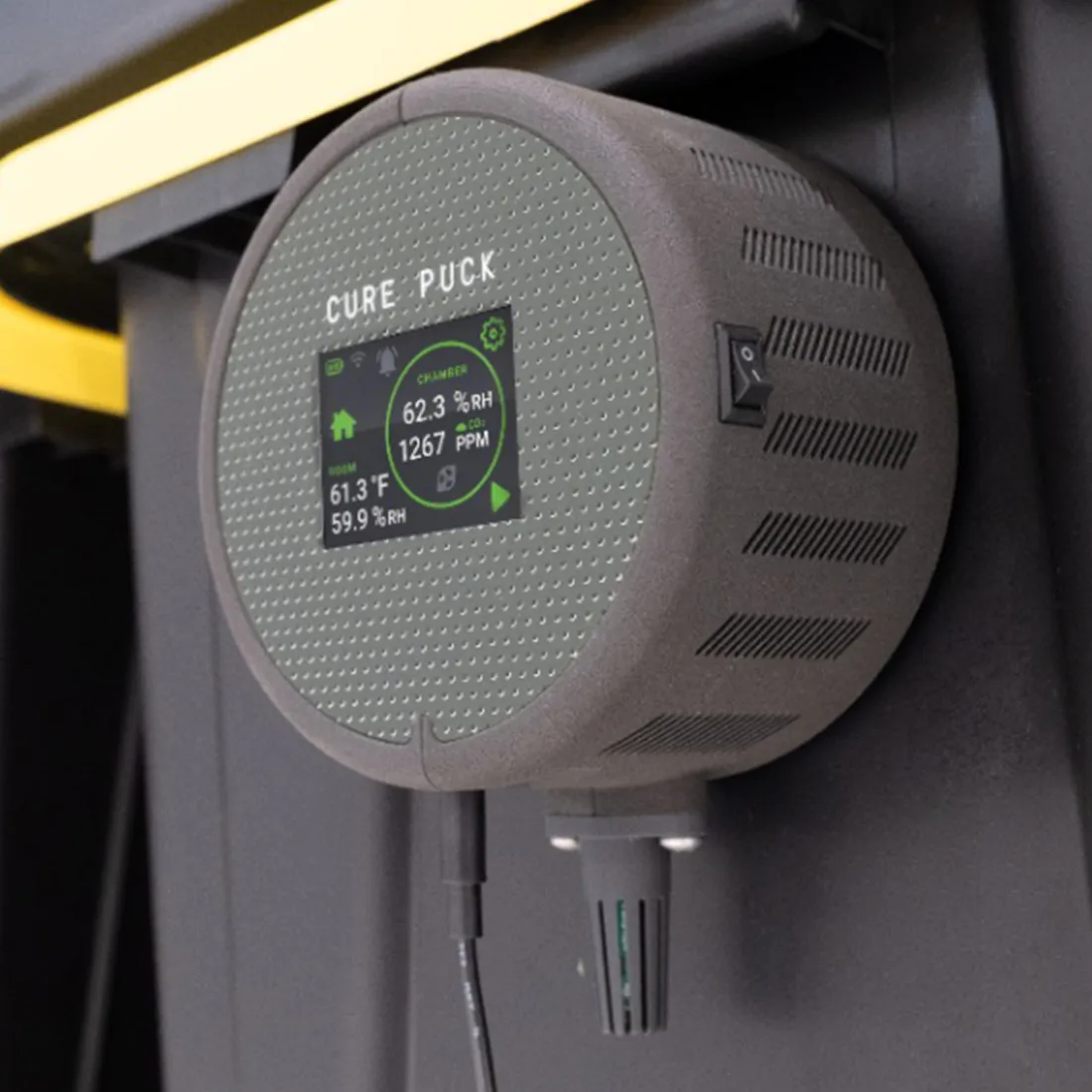 Cirkulær, flad puck i en klar, gennemsigtig blå farve med en glat overflade. Den har en let skrånende kant og en lille, indsat gummiknap i midten, der adskiller sig med en mørkere nuance. Pucken har en skinnende finish, der reflekterer lys, og den ses på en ensartet, lys baggrund, hvilket fremhæver dens form og farve.