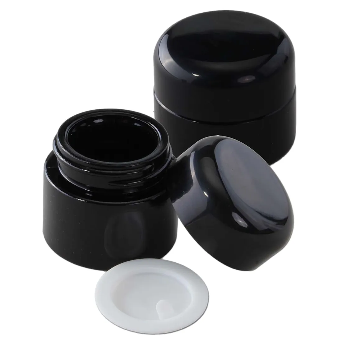 Lilla glasbeholder med en bred åbning, der gør det nemt at tilgå indholdet. Beholderen har en glat overflade og en rund form, hvilket giver et elegant udtryk. Den er 5 ml i størrelse og har en tæt skruelåg, der sikrer opbevaring. Farven varierer i nuancer af lilla, hvilket skaber en visuel dybde.