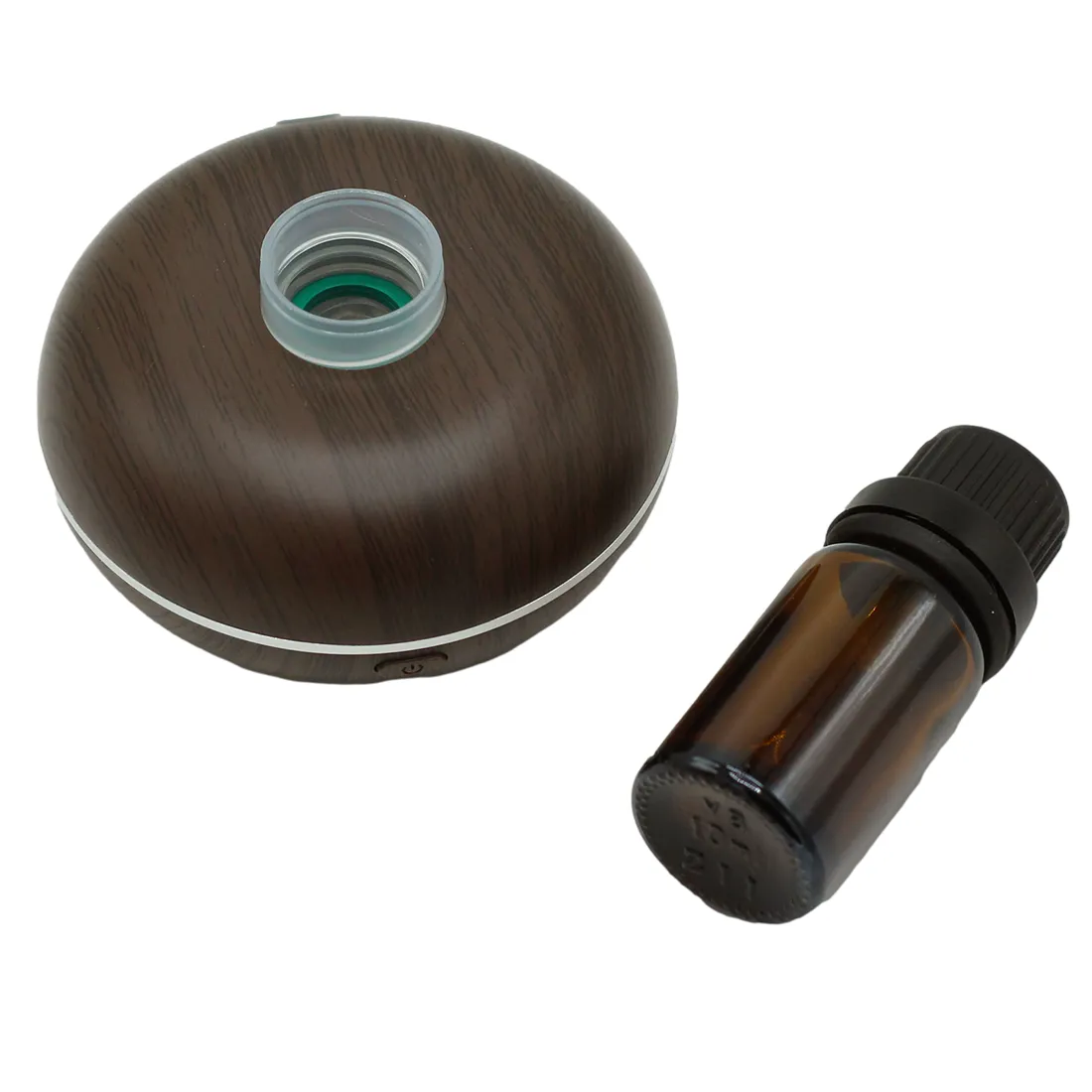 En kompakt, cylindrisk enhed i mat sort plast med en glat overflade. Foran sidder en gennemsigtig beholder til væske med en skruehætte. Øverst findes en tænd/sluk-knap, der er let tilgængelig. En lille, cirkulær åbning i toppen muliggør udsendelse af damp. Designet er minimalistisk med bløde former og en moderne æstetik.