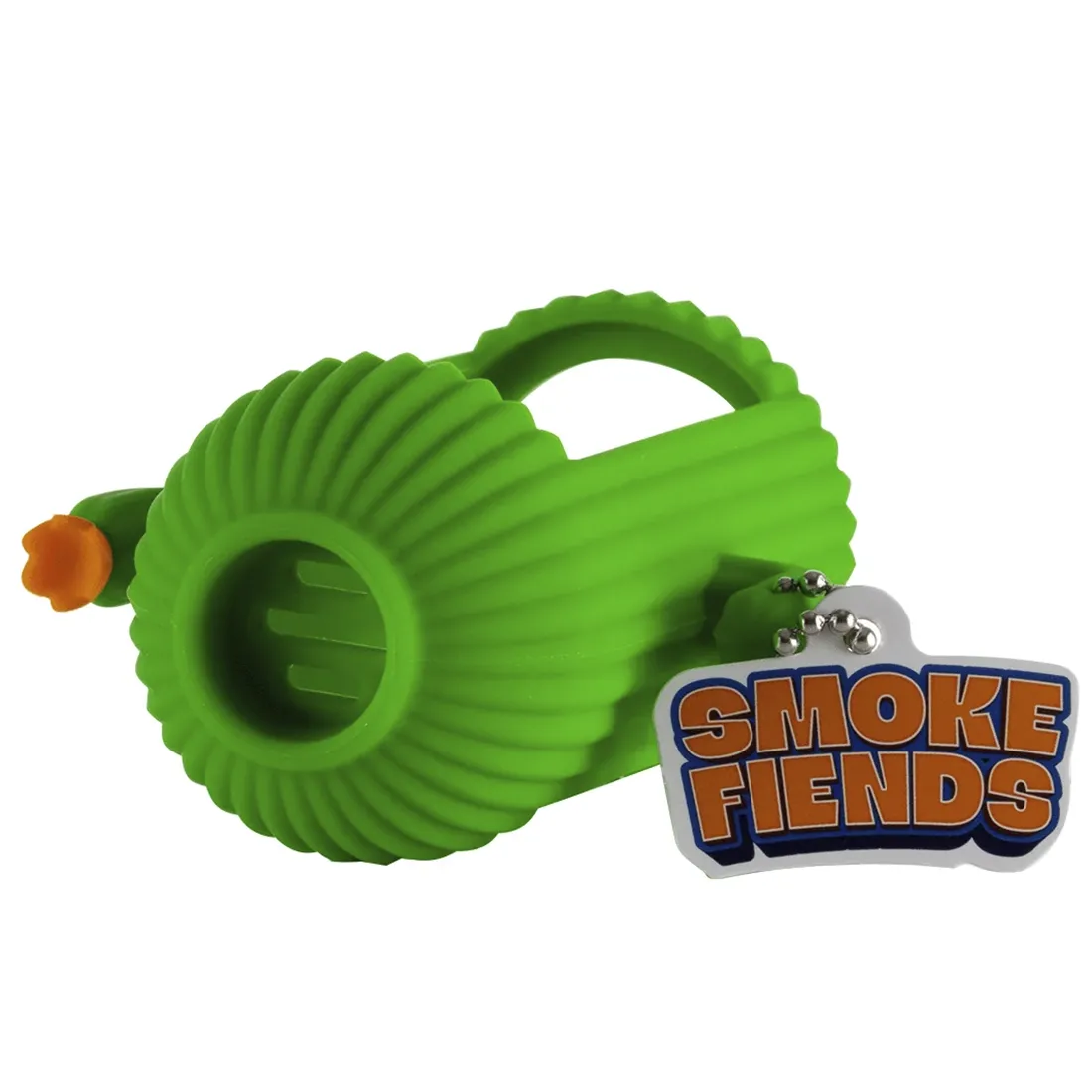 En grøn kaktusfigur med skarpe, trekantede blade pryder toppen af en cylinderformet enhed. Kaktussen har små, hvidlige prikker, der simulerer torne. En rund, sort base understøtter en gennemsigtig beholder med en let gullig væske indeni. En tynd slange strækker sig fra en af siderne, mens en lille knap og symboler er placeret på fronten af enheden.