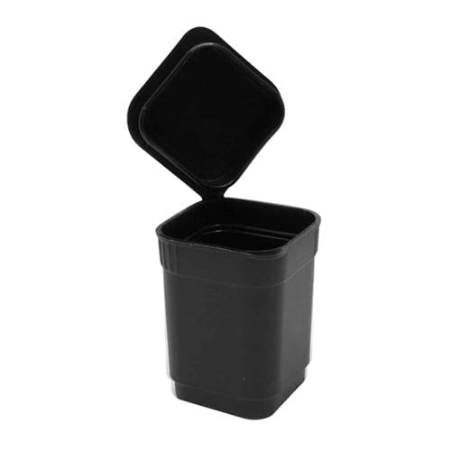 En firkantet beholder i sort plast med en mat overflade pryder midten af beskrivelsen. Låget har en glat, let buet form, der falder godt i tråd med beholderens stil. På låget er der en lille, rund knap, der fremstår som en kontrast i teksturen. Beholderen har en kapacitet på 10 gram og fremstår funktionel og stilren.