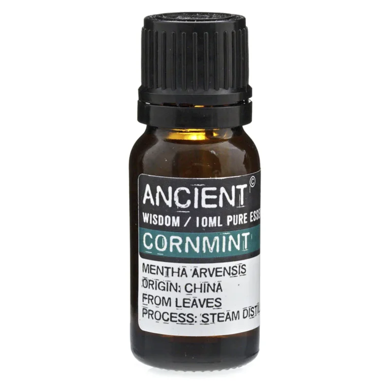 En gennemsigtig glasflaske med en mørkeblå væske indeni pryder en hvid etiket. Et sølvfarvet skruelåg topper flasken. Etiketdesignet indeholder sort tekst med produktinformation samt et symbol af en plante. Flaskens form er cylindrisk, og den står på en neutral overflade, der fremhæver dens elegante udseende.