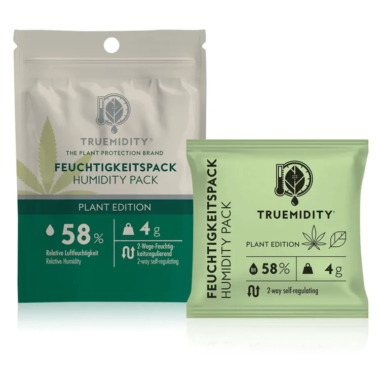 En cylinderformet enhed præsenterer et minimalistisk design i hvid og grå. Den har en glat overflade og en cirkulær åbning i toppen med en finmasket tekstilstruktur. En digital skærm med klare tal viser fugtighedsniveauet. Under skærmen er der to knapper i sort, med symboler for funktionalitet. Enheden er placeret på en flad overflade med en ensartet baggrund.