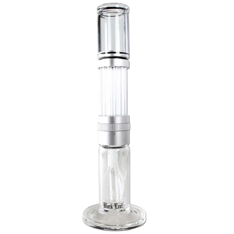 En sort glasbong præsenterer sig med en elegant, slank form, der strækker sig op til 35 cm i højden. Overfladen har en glat, skinnende tekstur, mens den nederste del er udstyret med en silverskinnende skål. Mønsteret af blade pryder bongen, hvilket tilføjer et dekorativt element. Kanten er præcist skåret, hvilket giver et stilrent udtryk.