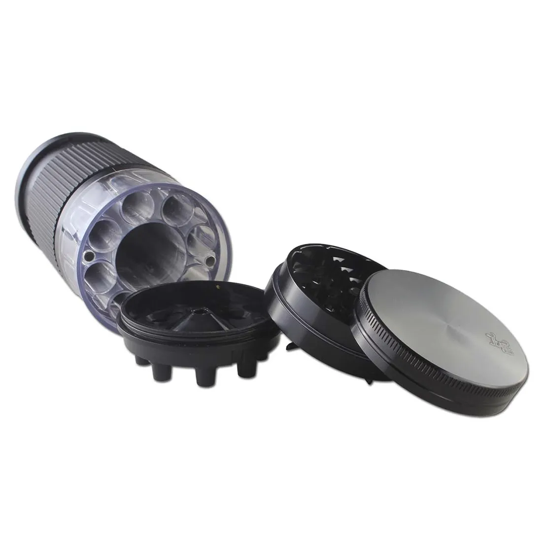 En sort kvadratisk grinder prydet med et bladmotiv i relief. Overfladen er glat med en mat finish, mens bladet har en blank overflade, der skaber kontrast. Grinderen er opdelt i flere sektioner, og der er en lille åbning til fyldning. En konisk fylder med en diameter på 69 mm er placeret ved siden af, også i sort, med en simpel, elegant form.