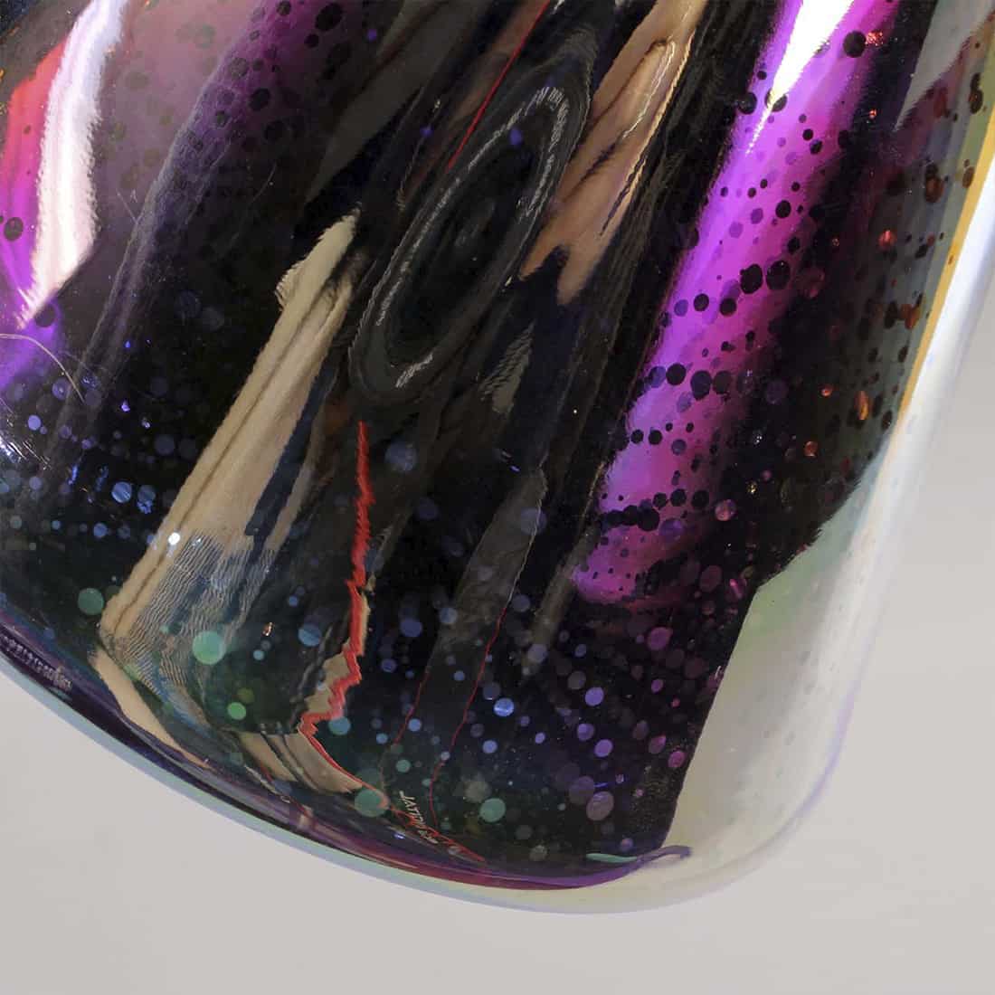 En transparent, farvet glasbong med en højde på 35 cm. Den har en slank, buet form, der udvides mod bunden. Øverste del indeholder en LED-lysring, der skaber et farverigt lys, mens bunden har en bred, stabil base. Røret er dekoreret med et mønster af farvede striber, og der er en skål til tobak.