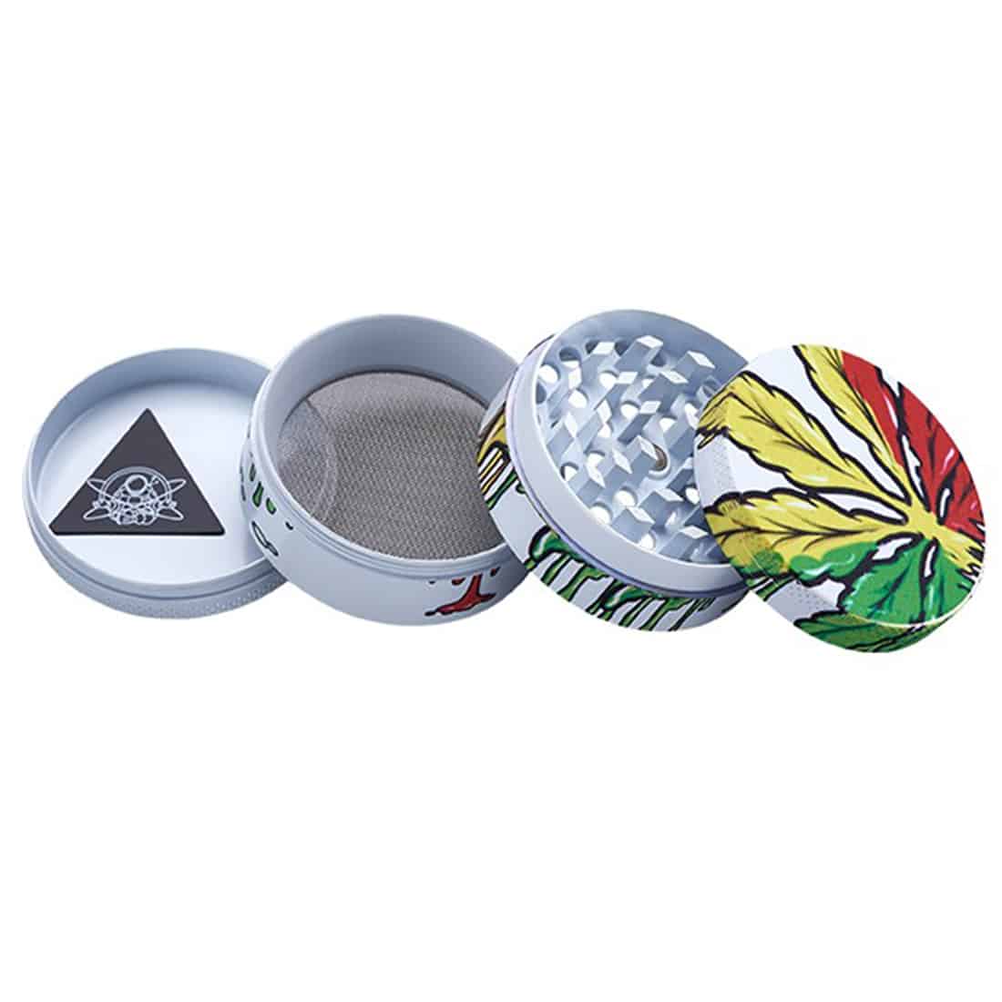 En kompakt, cylindrisk kværn i metal med en sort overflade og en glasskive i midten. Den har en glat tekstur og runde kanter. Kværnen er dekoreret med et bladmotiv, der fremstår i en lysere grøn nuance. Der er små åbninger til ventilation på siden, og den har et skruelåg med en riflet kant for nem åbning.